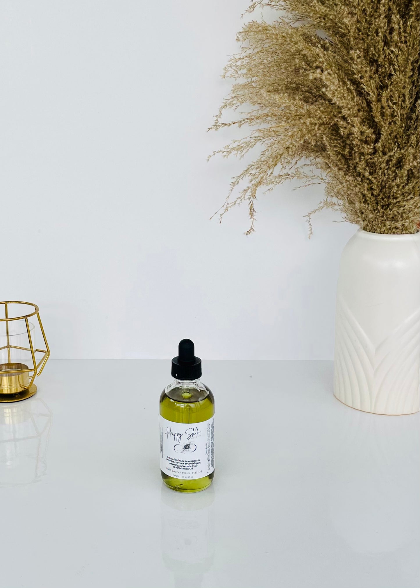Happy Skin Soap Co's Ayurvedic Hair Nourishment Oil with rich, natural color. Small size displayed