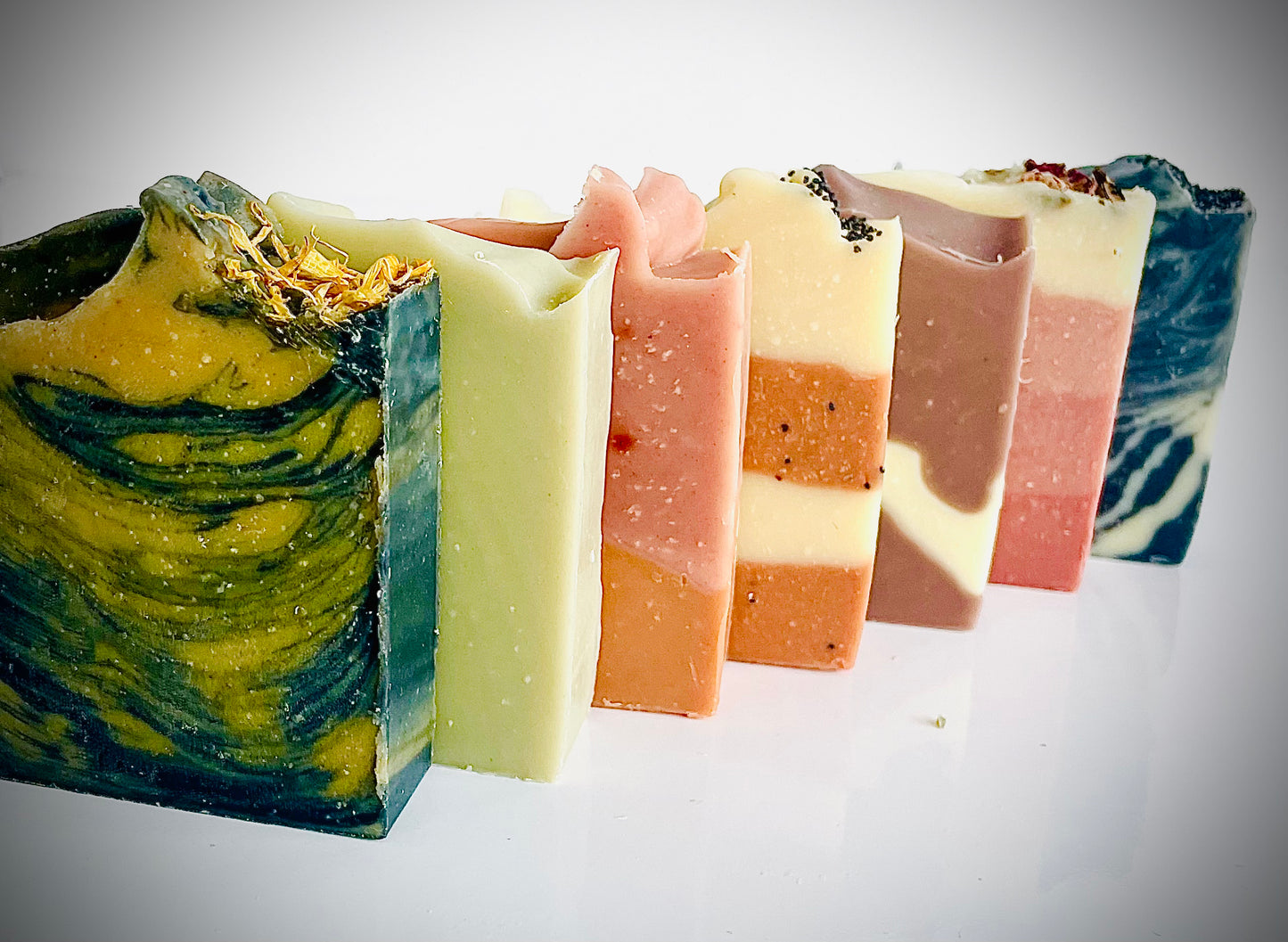 All Natural Soap Bars placed in a line one after the another with their front view visibleisible