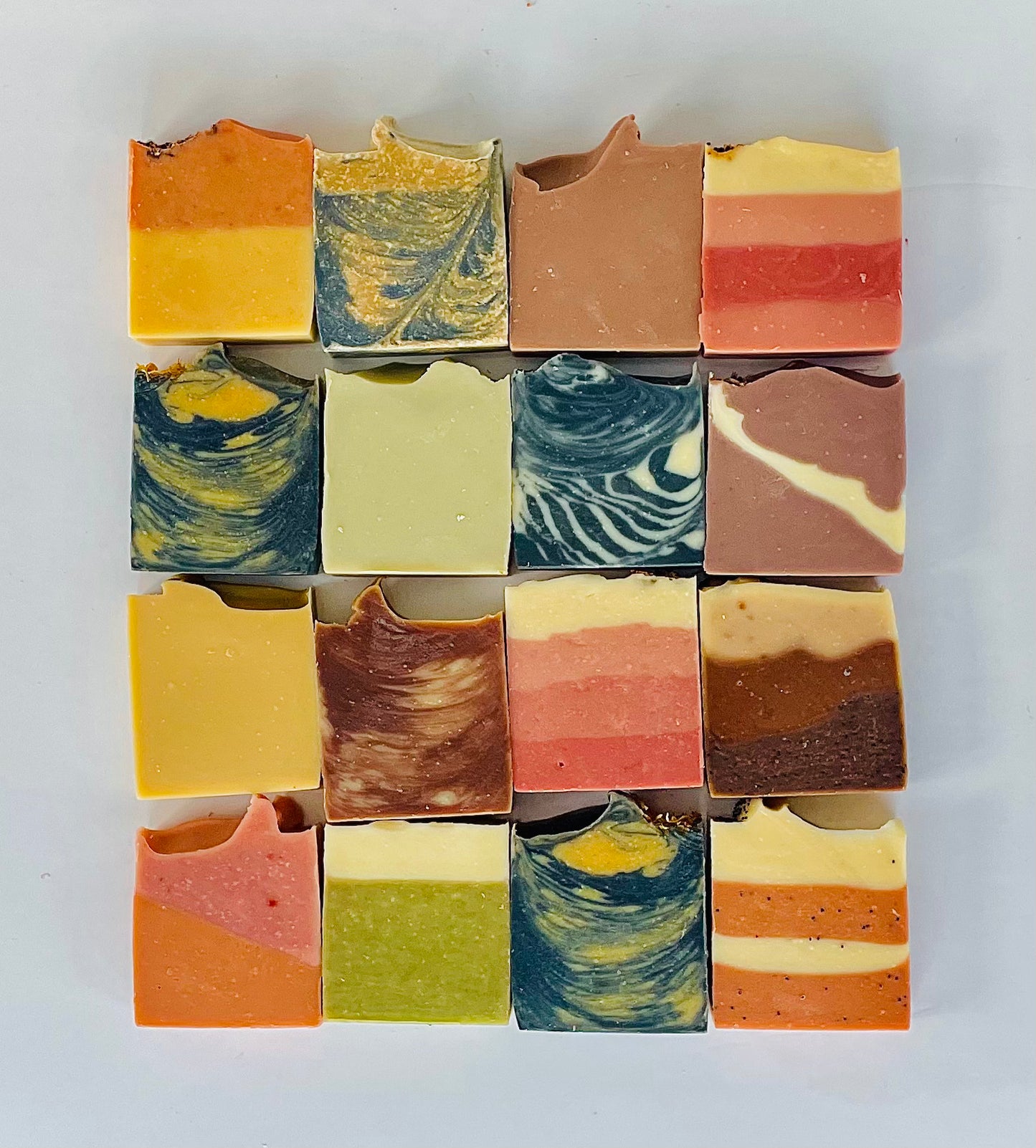 16 soap Bars - All Natural Soap Bars placed side by side forming a square of 4 soaps in each line. Soaps designs highly visiblesible